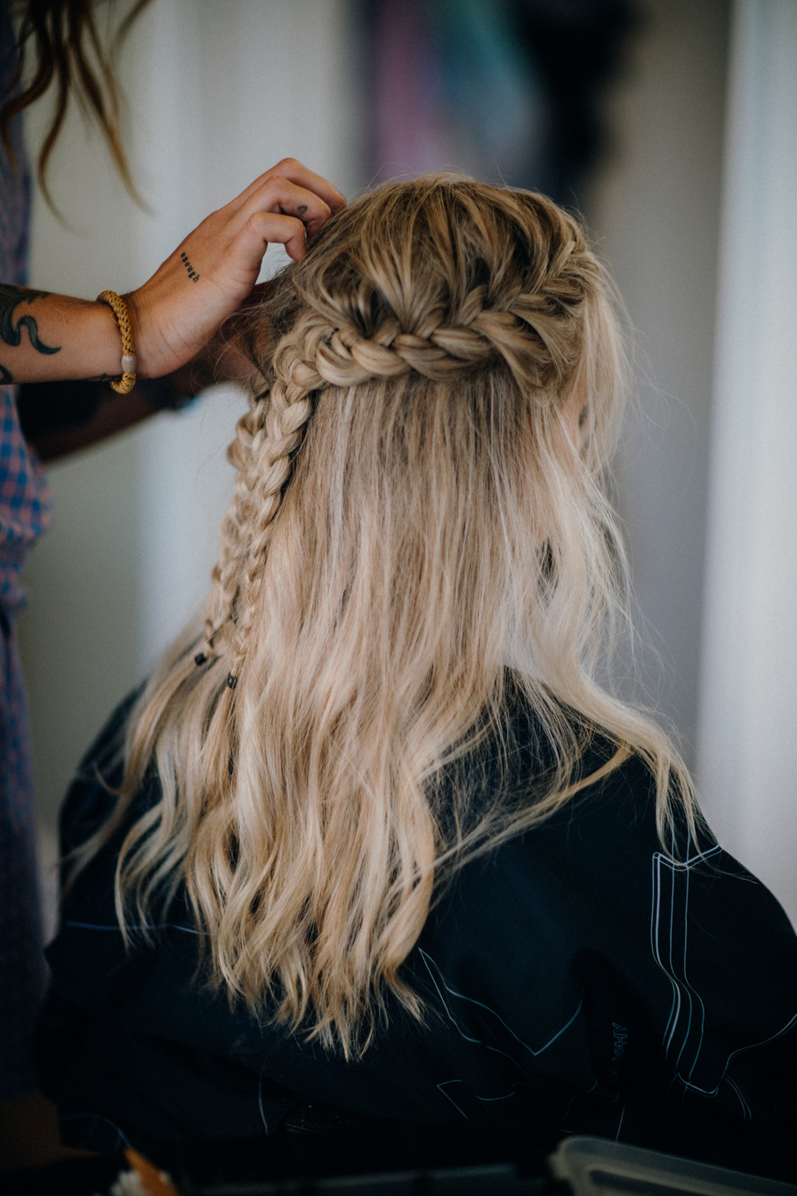 Person Braiding a Woman's Hair